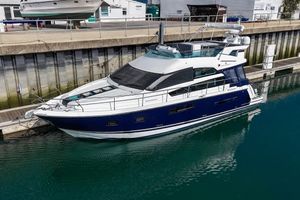 Fairline Squadron 42 2012 Fairline Squadron 42 yacht docked in a marina, featuring sleek design and modern amenities.