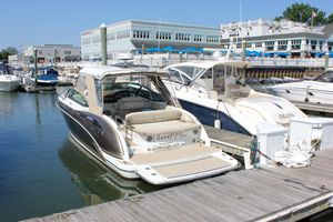 Formula 350 Crossover Bowrider 2017 Formula 350 CBR boat docked at a marina, surrounded by other boats.