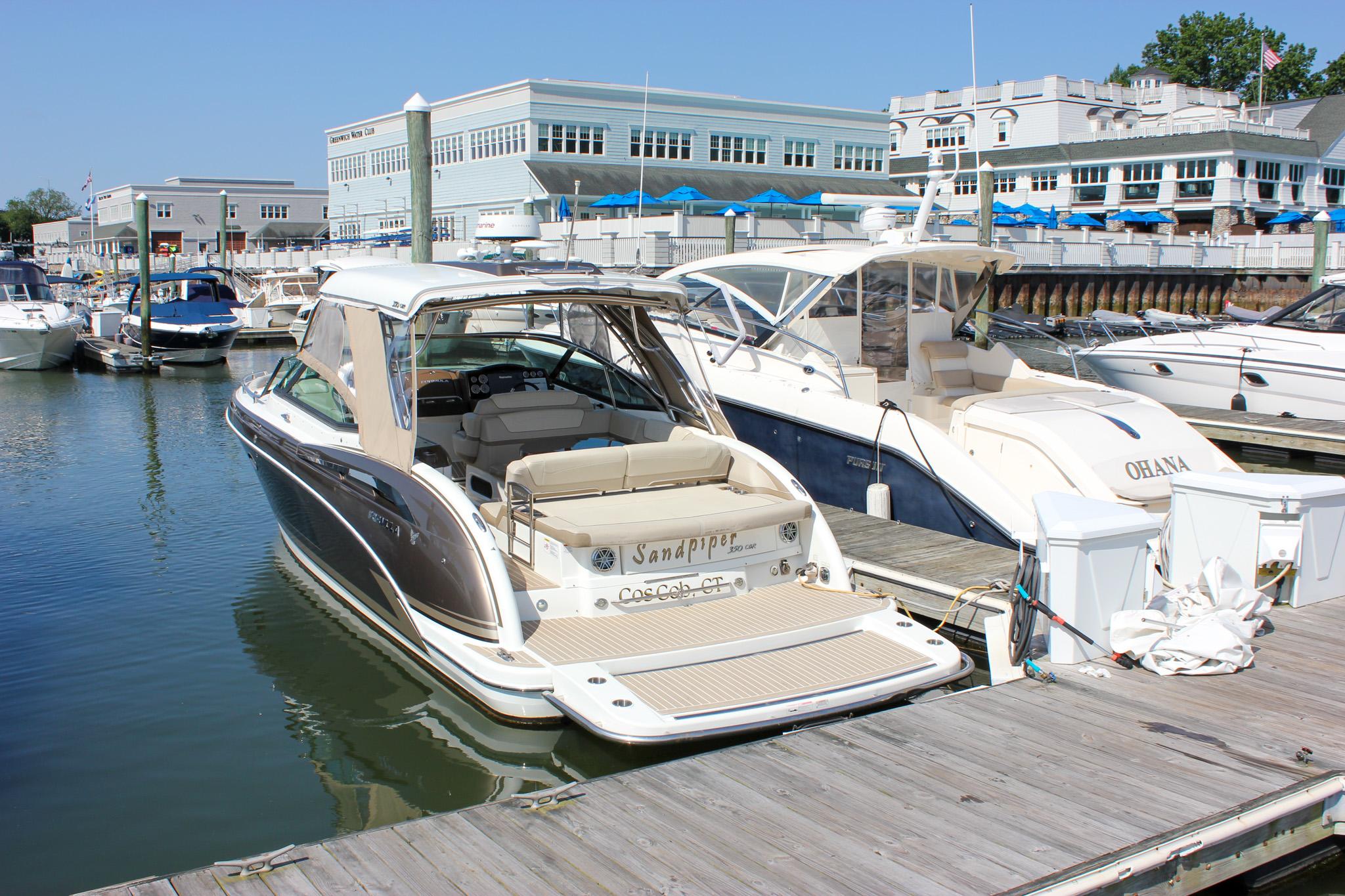 Formula 350 CBR 2017 Formula 350 CBR boat docked at a marina, surrounded by other boats.