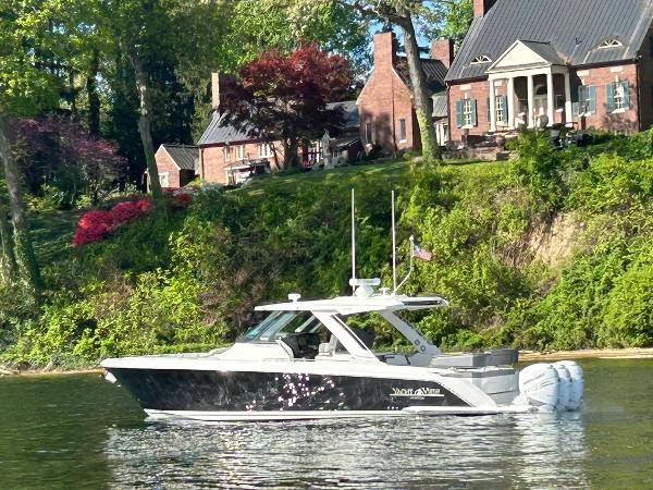 Tiara Yachts 38 LS 2021 Tiara Yachts 38 LS cruising on a scenic river near elegant brick homes.