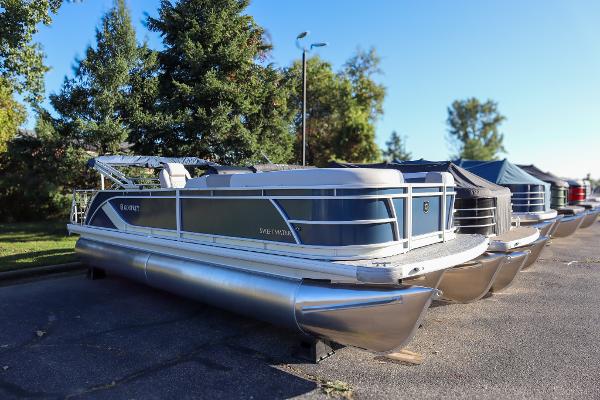 Godfrey SW2286SFLC Tritoon 2025 Godfrey SW2286SFLC Tritoon boat parked outdoors on a sunny day.