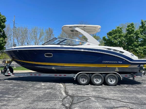 Chaparral 307 SSX 2017 Chaparral 307 SSX boat on trailer, blue and white design, parked outdoors.