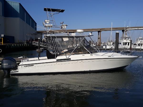 Contender 35 Express Side Console 1998 Contender 35 Express Side Console boat docked in marina, clear sky background.