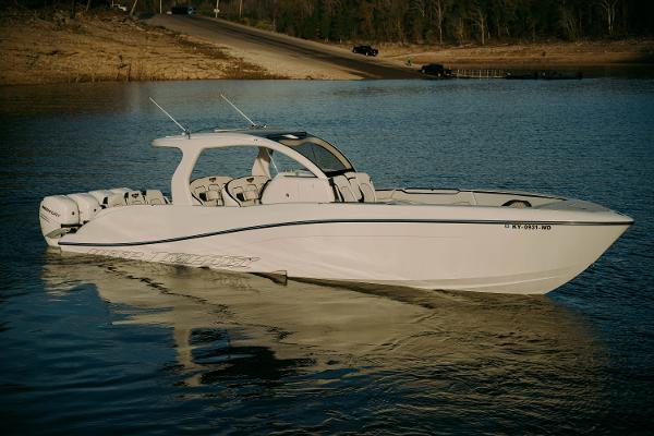 Deep Impact 399 Sport 2021 Deep Impact 399 Sport boat on calm water, showcasing sleek design and powerful engines.