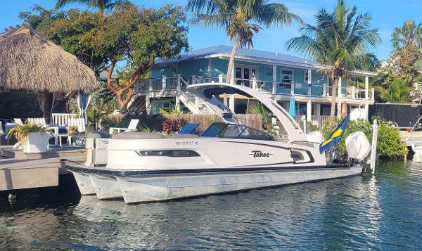 Tahoe Grand Tahoe ELW 2021 Tahoe Grand Tahoe ELW boat docked by a tropical waterfront home.
