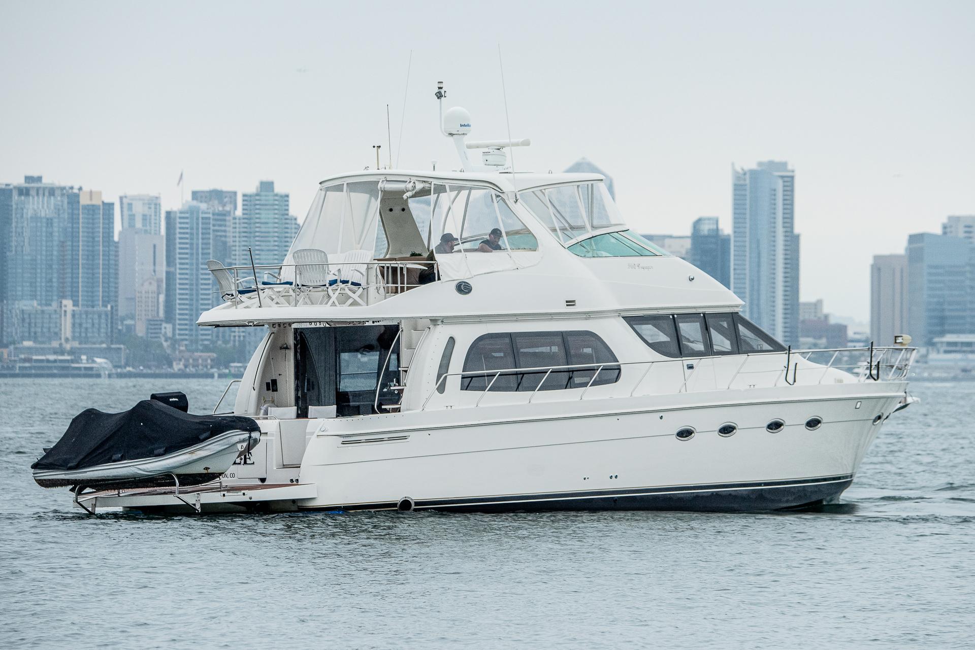 Carver 560 Voyager 2005 Carver 560 Voyager yacht cruising near city skyline.