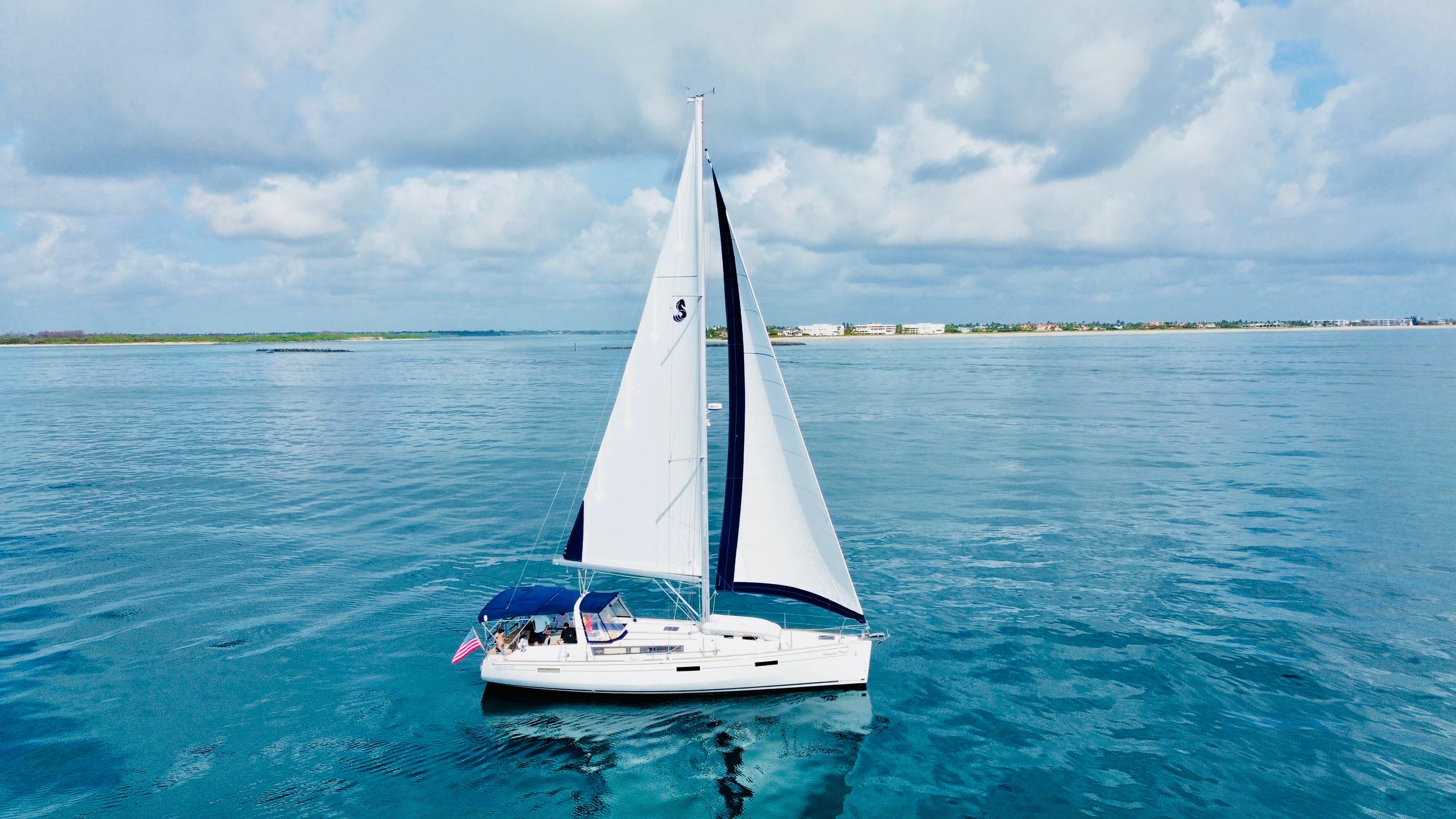 Beneteau Oceanis 45 Sailing yacht Beneteau Oceanis 45, 2015 model, cruising on calm blue waters under a cloudy sky.