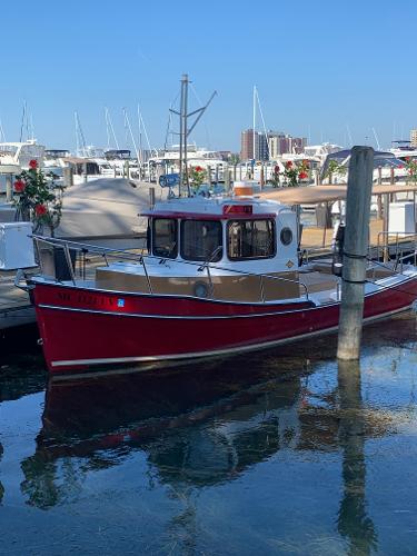 Ranger Tugs R-21 EC Red 2016 Ranger Tugs R-21 EC docked at a marina with clear blue skies.