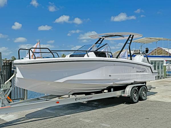 Axopar 25 Cross Top 2024 Axopar 25 Cross Top boat on trailer under clear blue sky.