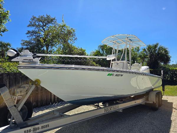 Pathfinder 2600 HPS 2013 Pathfinder 2600 HPS boat on trailer, parked outdoors under clear blue sky.