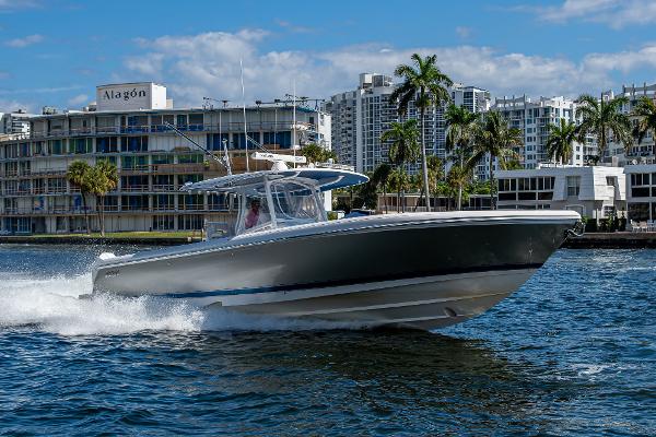 Intrepid 407 Nomad FE 2020 Intrepid 400 boat cruising on water near urban waterfront.