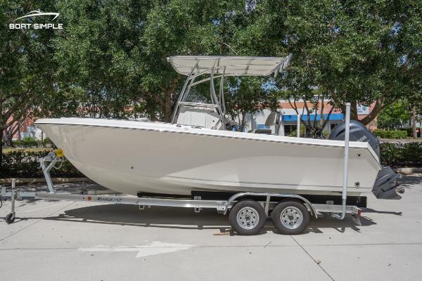 Sailfish 220 CC 2023 Sailfish 220 CC boat on trailer, parked outdoors, side view.