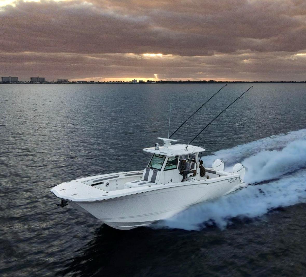 Caymas 34 CT 2024 Caymas 34 CT boat cruising on open water at sunset.