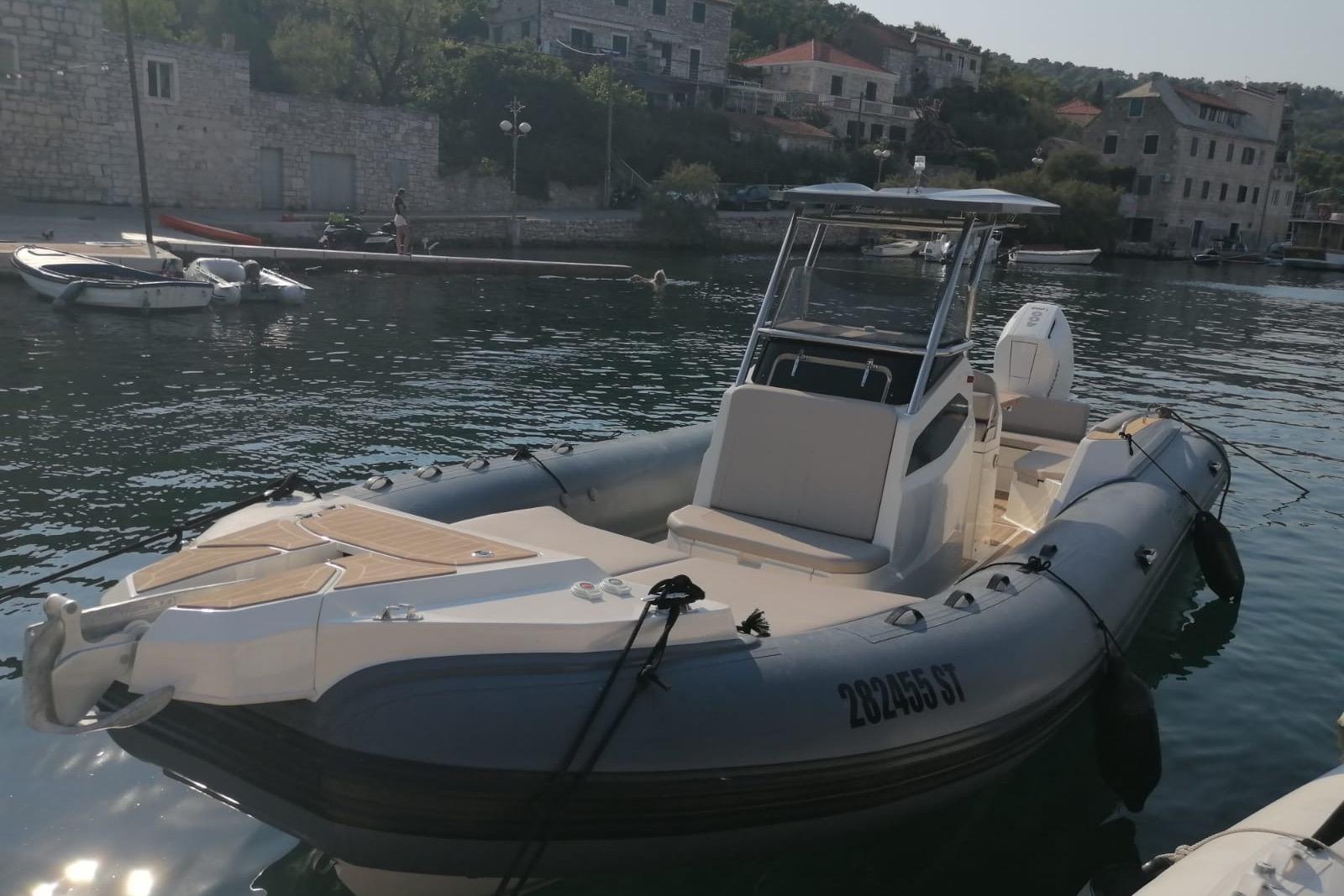 Capelli Tempest 900 Open 2023 Capelli Tempest 900 Open boat docked in a scenic harbor.