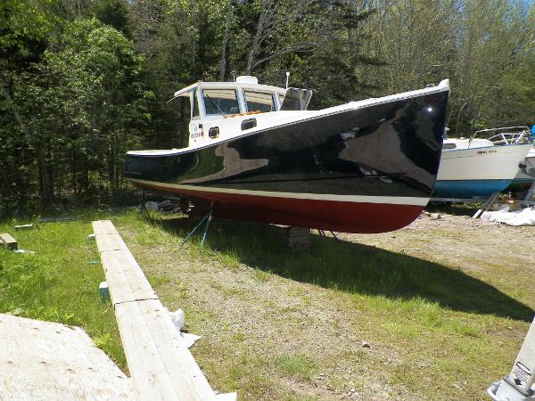 Custom Holland Hardtop Cruiser Custom 2000 Holland Hardtop Cruiser boat on land, surrounded by trees and grass.