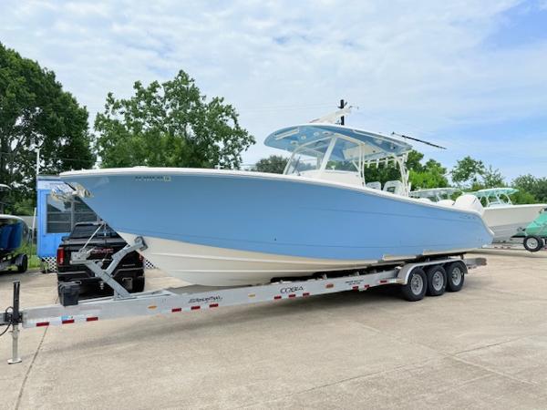Cobia 350 Center Console 2020 Cobia 350 Center Console boat on a trailer, light blue hull, parked outdoors.