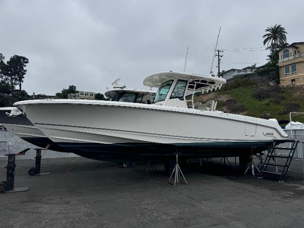 Boston Whaler 330 Outrage 2022 Boston Whaler 330 Outrage boat on stands, parked outdoors.