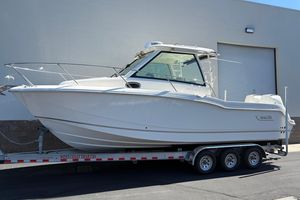 Boston Whaler 285 Conquest 2026 Boston Whaler 285 Conquest boat on trailer, parked outside a building.