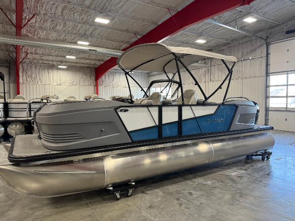 Sylvan A-22 Sport 2025 Sylvan A-22 Sport pontoon boat in showroom, featuring sleek design and canopy.