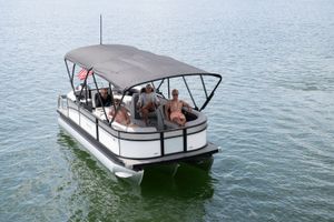 Barletta Aria 22 QC 2026 Barletta Aria 22 QC pontoon boat with passengers on a calm lake.