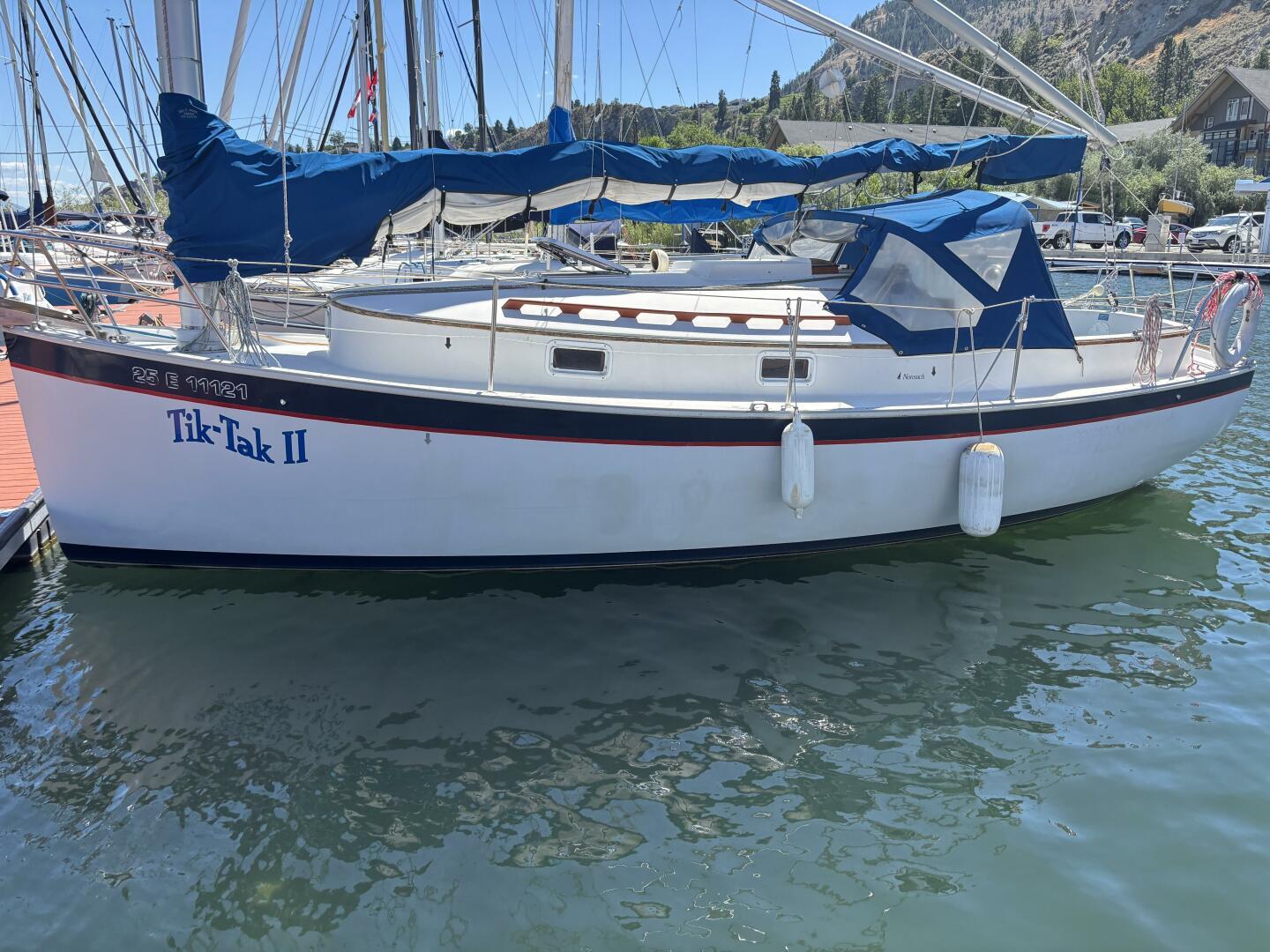 Hinterhoeller Nonsuch 26 Classic 1985 Hinterhoeller Nonsuch 26 Classic sailboat, "Tik-Tak II," docked with blue covers.