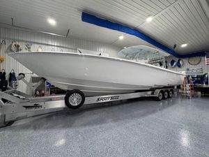 Contender 44 ST 2024 Contender 44 ST boat on trailer in a spacious indoor garage.