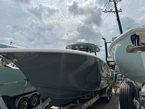 Tidewater 320 CC Adventure 2025 Tidewater 320 CC Adventure boat on trailer under cloudy sky.
