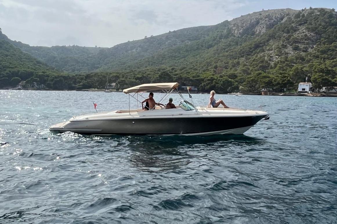Chris-Craft Corsair 32 2016 Chris-Craft Corsair 32 boat cruising on scenic water with passengers.