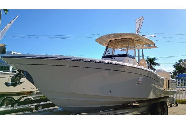 Grady-White 281 Coastal Explorer 2025 Grady-White 281 Coastal Explorer boat on trailer under clear blue sky.