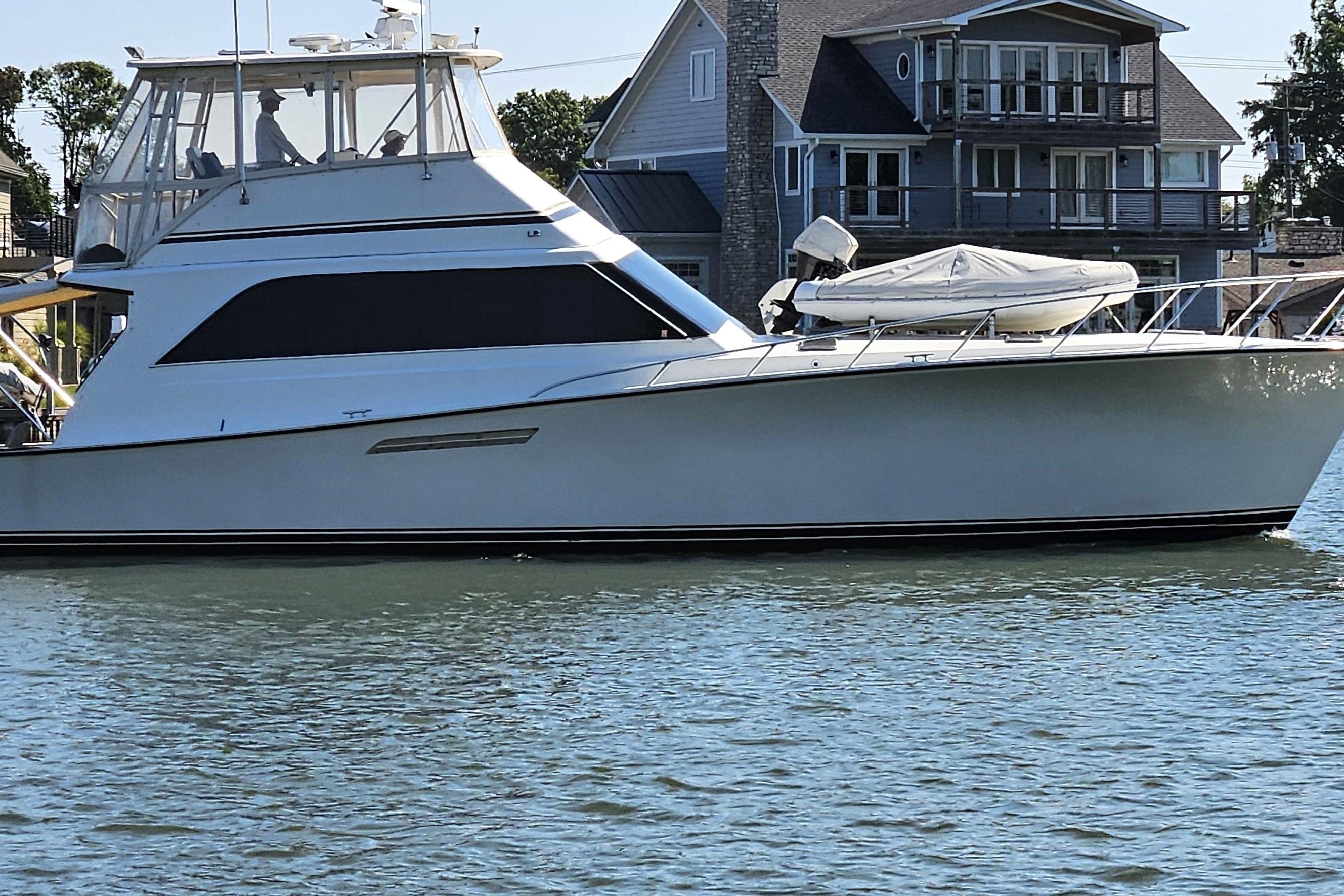 Ocean Yachts 55 Super Sport 1988 Ocean Yachts 55 Super Sport on calm water near waterfront homes.