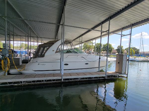 Cruisers Yachts 370 Express 2004 Cruisers Yachts 370 Express docked under a covered marina.