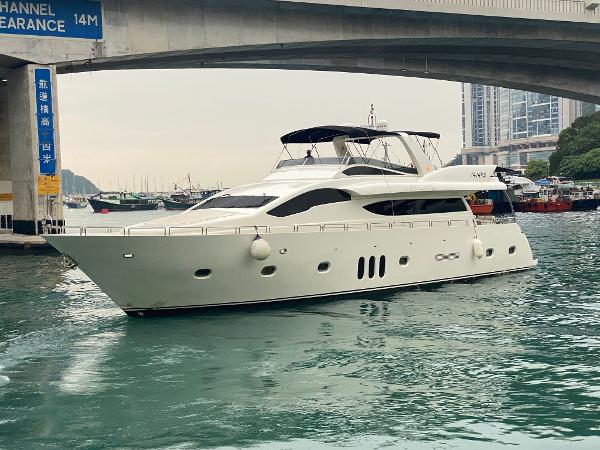 Custom Accelera 82 Luxurious 2014 Custom Accelera 82 yacht cruising under a bridge in a serene harbor.