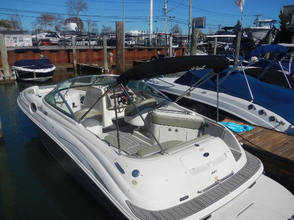 Sea Ray 240 Sundeck 2006 Sea Ray 240 Sundeck boat docked at marina, featuring spacious seating and sleek design.