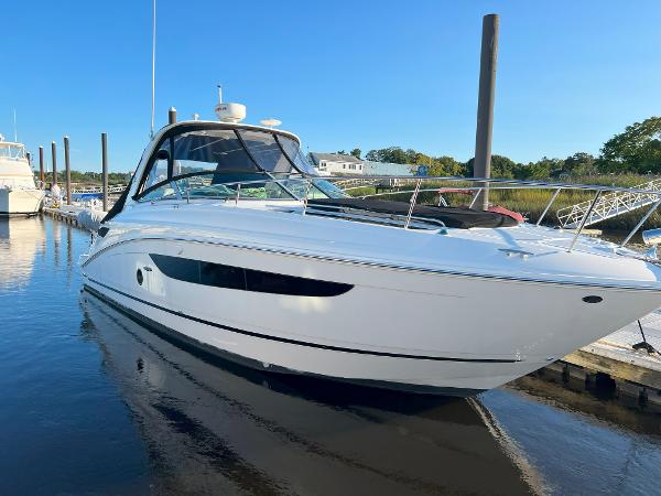 Sea Ray 350 Sundancer 2014 Sea Ray 350 Sundancer yacht docked in a serene marina setting.