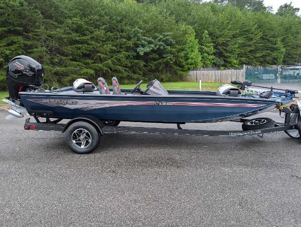 Ranger RT198P 2024 Ranger RT198P fishing boat on trailer, parked outdoors.