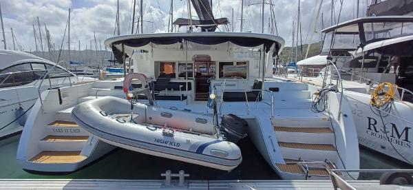 Lagoon 450 F Lagoon 450 F 2018 catamaran docked at marina with inflatable dinghy on deck.