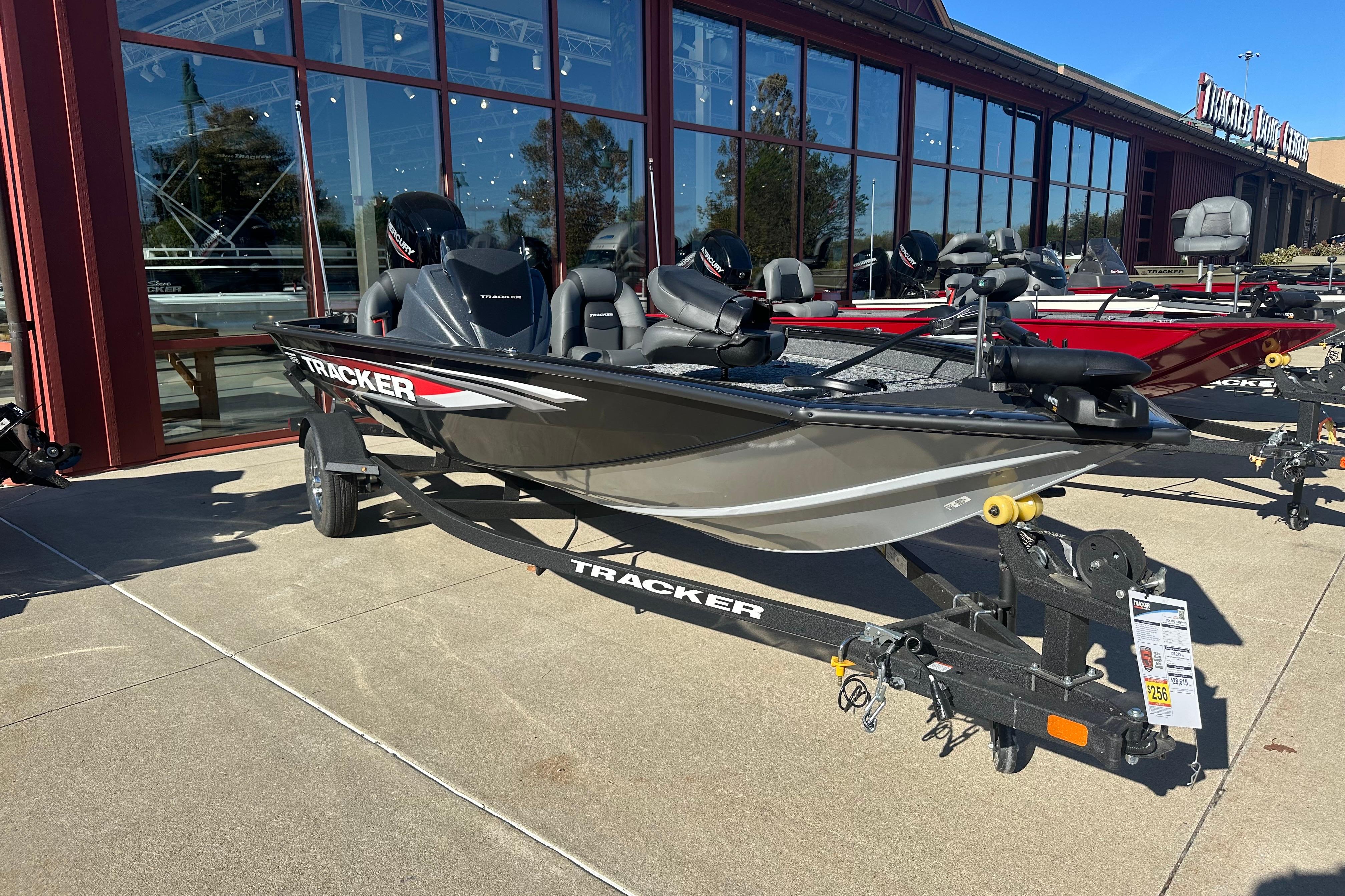 Tracker Pro Team 175 2026 Tracker Pro Team 175 boat displayed outside a showroom on a trailer.