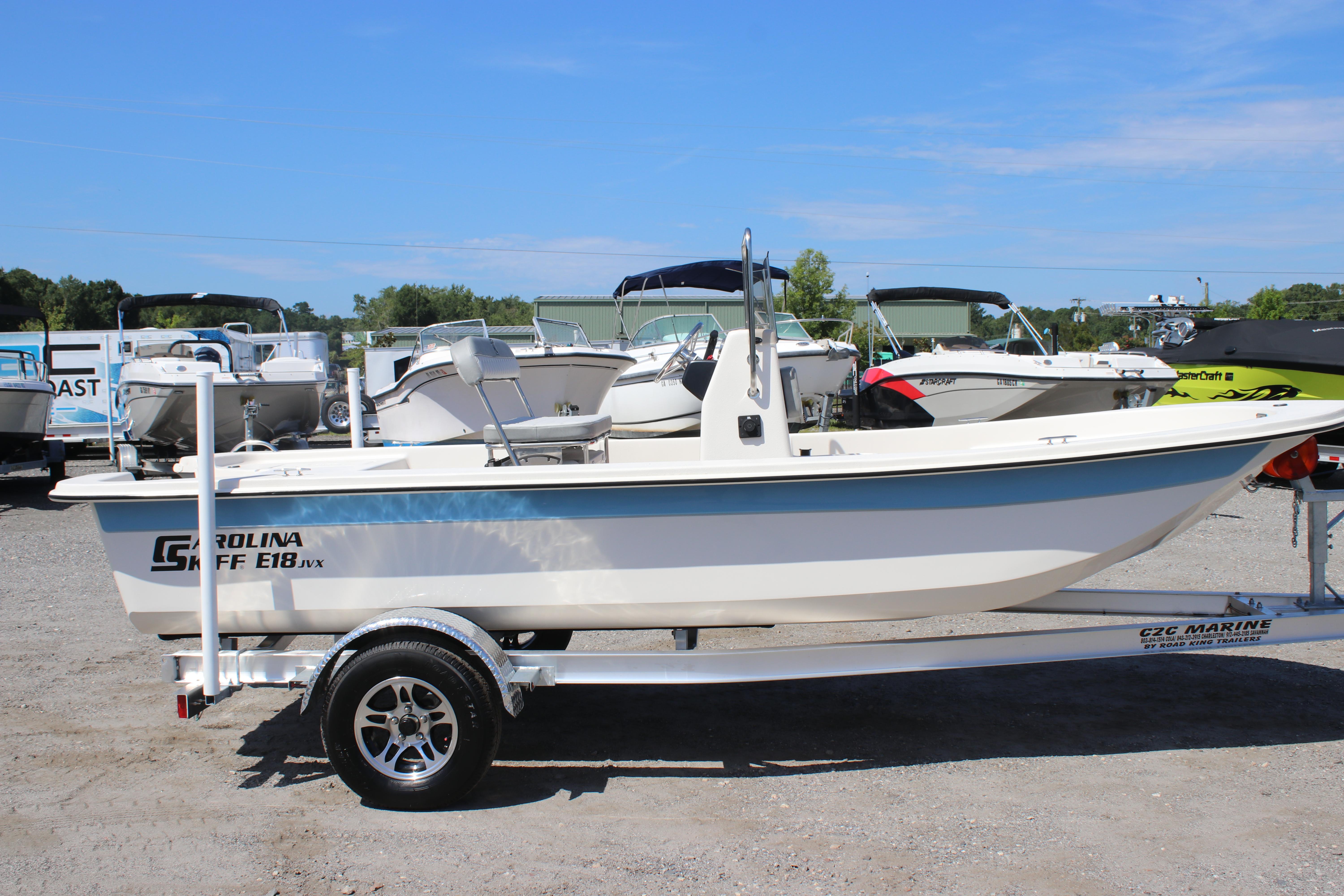 Carolina Skiff E18 JVX CC 2025 Carolina Skiff E18 JVX CC boat on trailer in outdoor showroom.