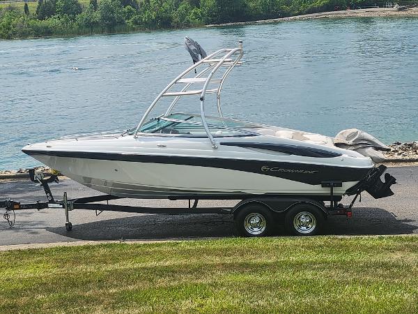 Crownline 21 SS 2014 Crownline 21 SS boat on trailer by a lake.