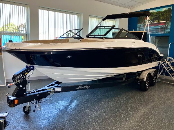 Sea Ray SPX 210 2024 Sea Ray SPX 210 boat on trailer in showroom.