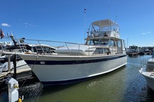 Chris-Craft 47 Commander 1974 Chris-Craft 47 Commander yacht docked in a marina under clear blue skies.