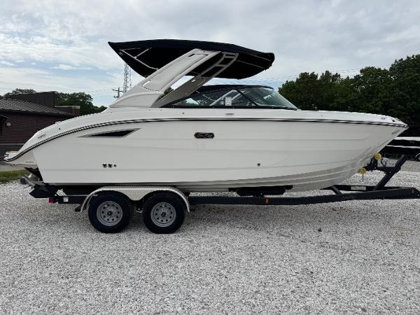 Sea Ray SDX 250 2025 Sea Ray SDX 250 boat on a trailer, parked on gravel.