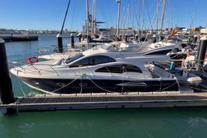 Astondoa 43 GLX 2006 Astondoa 43 GLX yacht docked in a marina under clear blue skies.