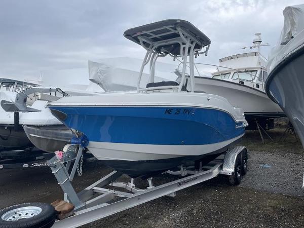 Finseeker 210 FS 2023 Finseeker 210 FS.2 boat on trailer, blue and white hull, parked outdoors.