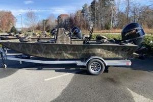 G3 Bay 19 GX 2026 G3 Bay 19 GX boat on trailer, parked outdoors, with trees in the background.
