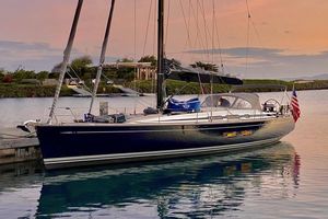 Nautor Swan 54 Sailing yacht Nautor Swan 54, 2018 model, docked at sunset with American flag.