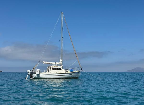 Com-Pac CP 23 Pilothouse 2022 Com-Pac CP 23 Pilothouse sailboat anchored on calm blue sea.