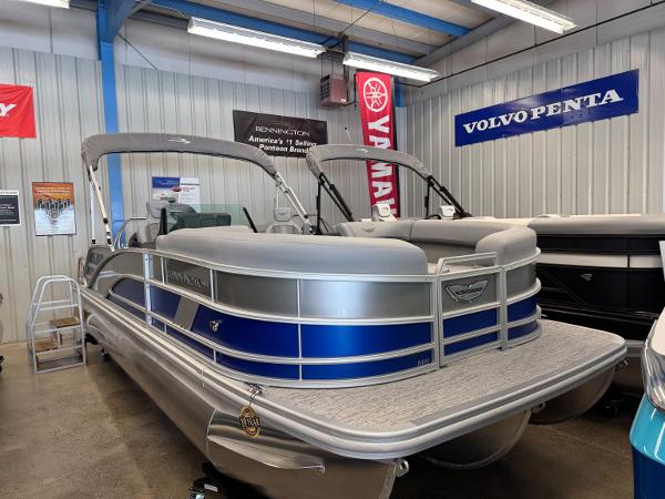 Bennington 22 MSB 2025 Bennington 22 MSB pontoon boat displayed in a showroom with banners.
