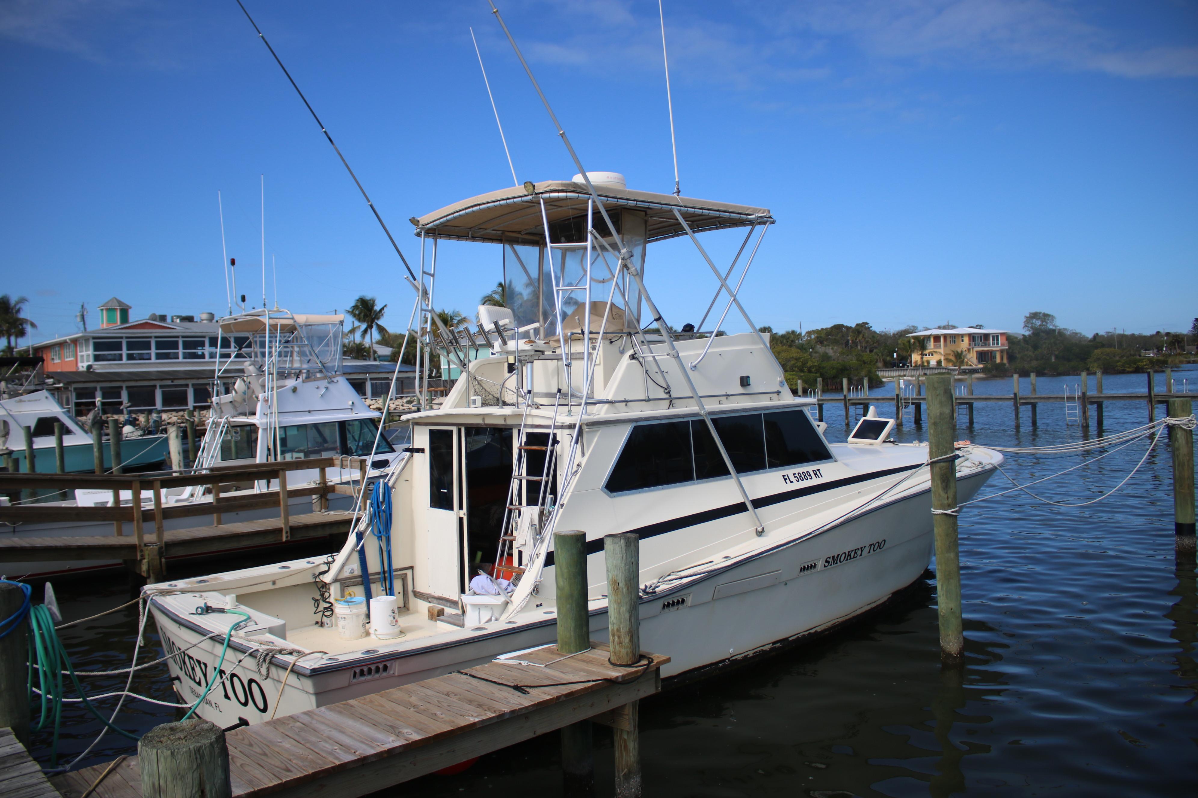 Viking Boats 40 Sport fish 1974 Viking Boats 40 Sport Fish docked at marina, clear blue sky background.