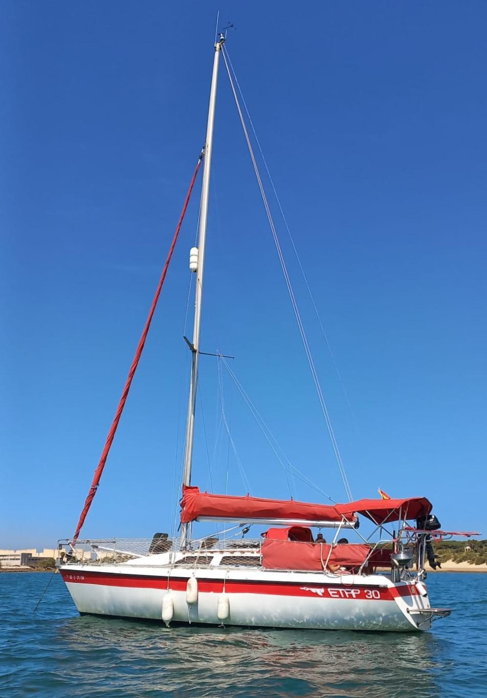 Etap 30 Sailboat Etap 30, 1991 model, with red sails on calm blue water.